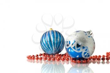 Christmas decoration -  two blue balls and red beads over white