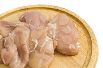 Close-up of Chicken fillet and on hardboard over white
