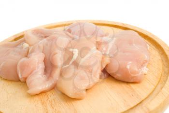 Close-up of Chicken fillet on hardboard isolated over white