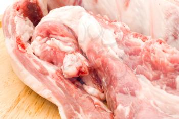 Close-up of Raw pork meat on round hardboard