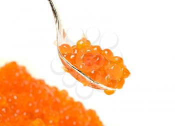 Close-up of spoon with Red caviar. Delicatessen on white
