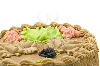 Closeup of Birthday chocolate cake with creamy leaves over white