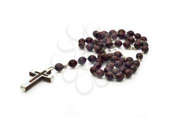 Closeup of Wooden beads isolated over white (shallow DOF). Focused on the cross