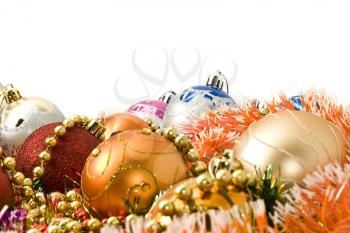 Colorful Christmas decoration balls and bright tinsel over white