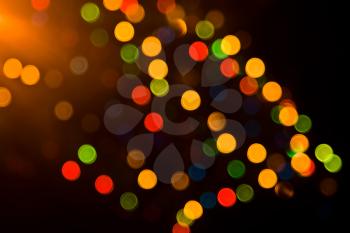 Festive colorful lights over black. Useful as background