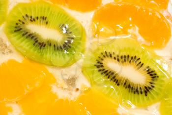 Fruit background. Sliced kiwi and mandarin segments