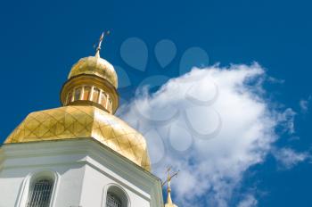 Golden Cupola of Orthodox church and blue sky with clouds