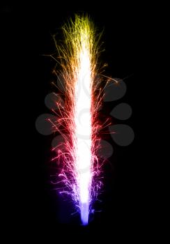 Gradient colored birthday fireworks candle over black