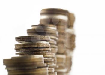 Growth - towers assembled of coins shallow DOF with focus on the left side of the image