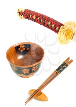 Japanese katana, Chopsticks and bowl over white