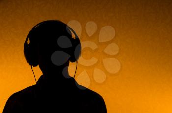 Listen to the Music - silhouette of man with earphones (back light)
