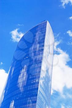Modern cityscape: tall skyscraper over blue sky