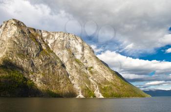 Mountains and fjord in Norway. Cloudy sky