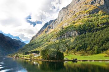 Norwegian fjords: Mountains, village and blue sky