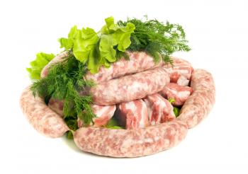 Pieces of Pork meat and Sausages. Isolated over white