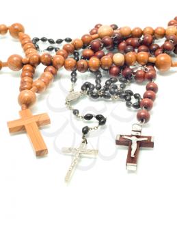 Religion - beads over white with focus on cross (shallow DOF)