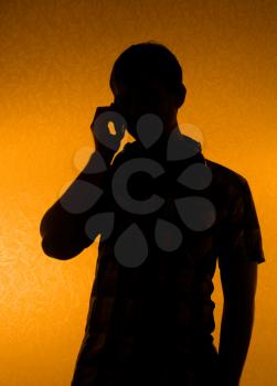 Communication - silhouette of man speak over the phone (back light)