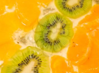 Tasty Fruit background. Sliced kiwi and orange segments