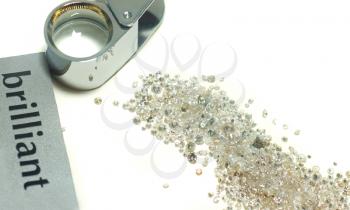 Sorting of gems - diamonds and loupe over white