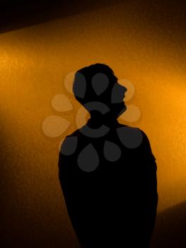 Studio shot - silhouette of man in the darkness