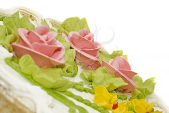 Tasty desert - Close-up of cake with cream, pink roses and green leaves