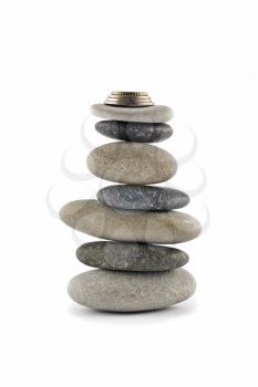 Welfare and Stability  - Balanced stone stack or tower with coins on top over white