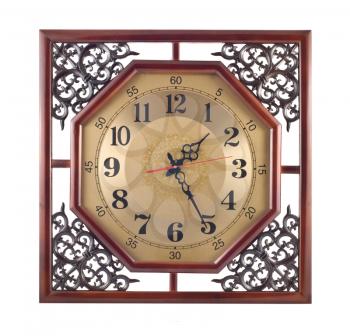 Antique wall clock with carved wooden frame isolated over white