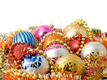 Beautiful Christmas decoration - balls and colorful tinsel over white