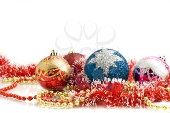 Beautiful Christmas decoration - colorful tinsel and balls over white