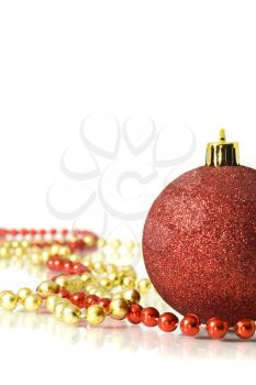 Christmas is coming. Decoration - colorful red ball and beads over white background