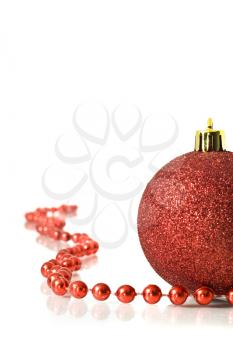Christmas is coming. Red Decoration ball and red tinsel over white