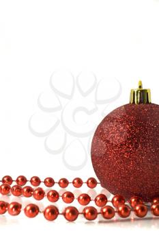 Christmas is coming. Red Decoration - ball and tinsel over white background