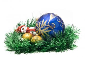 Christmas toy with three colorful New Year decoration Balls and green tinsel over white