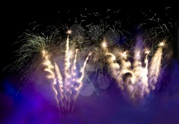 Fireworks in the lilac smoke at night in the sky useful as festive background
