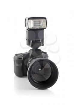 Professional DSLR camera with telephoto lens and flash isolated over white