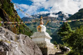 Buddhism: stupe or chorten with prayer flags in Himalayas. Religious life in Nepal