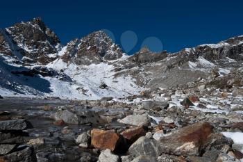 Renjo pass: mountain peaks and stream in Himalayas. Hiking in Nepal