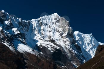 Snowbound mountain range and blue sky in Himalayas. Travel to Nepal