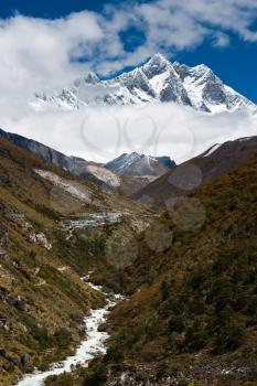 Lhotse and Lhotse shar peaks. Village and stream in Himalayas. Pictured in Nepal