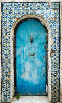 Blue aged door with ornament and tiles from Sidi Bou Said in Tunisia. Large resolution