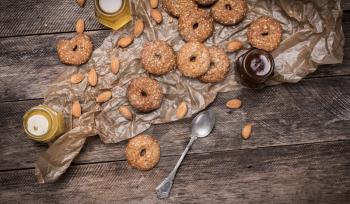 Nuts and Cookies with sesame on wooden table. Rustic style and autumn food photo