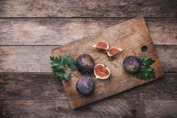 rustic style Cut figs on chopping board and wooden table. Autumn season food photo