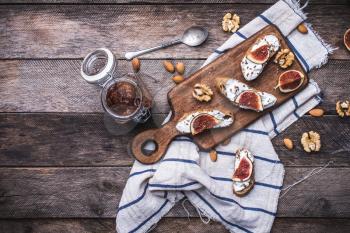 Bruschetta with figs and nuts on board in rustic style. Breakfast, lunch food photo