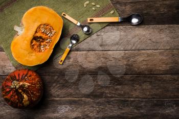 Rustic style pumpkins with seeds on green napkin and wood. Autumn Season food photo