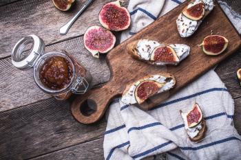 rustic style tasty Bruschetta with jam and figs on napkin. Breakfast, lunch food photo