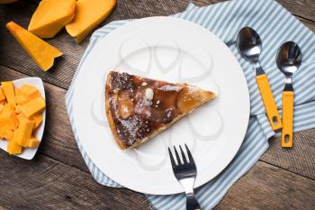 pieces of pumpkin and pie on plate in Rustic style. Food Photo