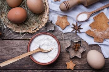 Flour and eggs for Christmas pastry and holiday cookies in rustic style