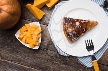 pie on plate and pieces of pumpkin in Rustic style. Food Photo