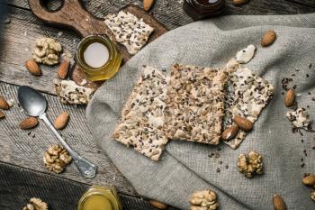 dietary Cookies with  honey and nuts on napkin and wooden table. Rustic style and autumn food photo