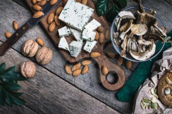 nuts mushrooms, cheese and bread buns for healthy eating in rustic style